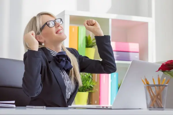 Lady at an office desk celebrating